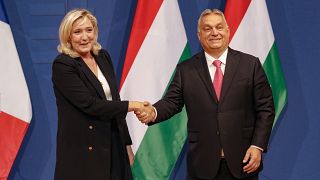 French far-right leader Marine le Pen, left, shakes hands with Hungarian Prime Minister Viktor Orban after a joint press conference in Budapest, Hungary, 26 October 2021.