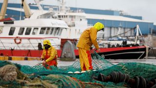 French fishermen repair their nets at Boulogne-sur-Mer