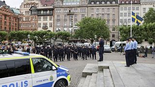 Police officers gather for a minute of silence in Malmo days after the murder.