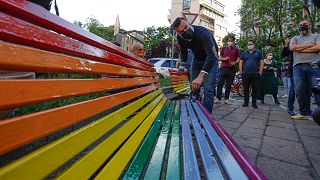 MP and gay rights activist Alessandro Zan paints a bench in the colors of the rainbow, in Milan, Italy, Friday, May 7, 2021