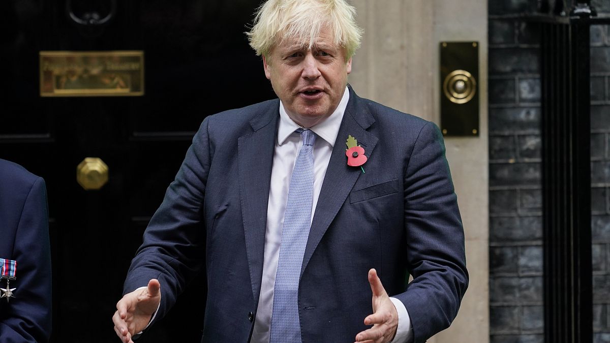 Britain's Prime Minister Boris Johnson meets with fundraisers for the Royal British Legion and purchases a poppy in front of 10 Downing in London, Friday, Oct. 29, 2021.