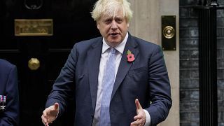 Britain's Prime Minister Boris Johnson meets with fundraisers for the Royal British Legion and purchases a poppy in front of 10 Downing in London, Friday, Oct. 29, 2021.