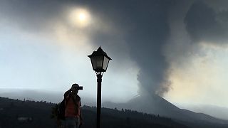 Tourist filming the volcano with his mobile phone