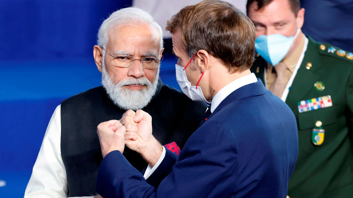 French President Emmanuel Macron, right, speaks with India's Prime Minister Narendra Modi during a group photo at the G20 summit.