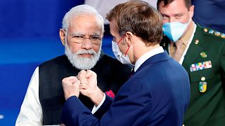 French President Emmanuel Macron, right, speaks with India's Prime Minister Narendra Modi during a group photo at the G20 summit.