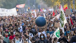 Demonstrators march in Rome, Saturday, Oct. 30, 2021, the day a Group of 20 summit started in the Italian capital.