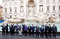 Leaders of the G20 throw coins inside the Trevi Fountain during an event for the G20 summit in Rome, Sunday, Oct. 31, 2021.