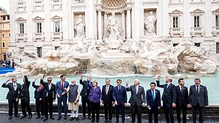 Leaders of the G20 throw coins inside the Trevi Fountain during an event for the G20 summit in Rome, Sunday, Oct. 31, 2021.