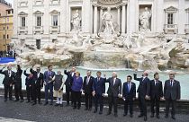 Leaders of the G20 throw coins inside the Trevi Fountain.