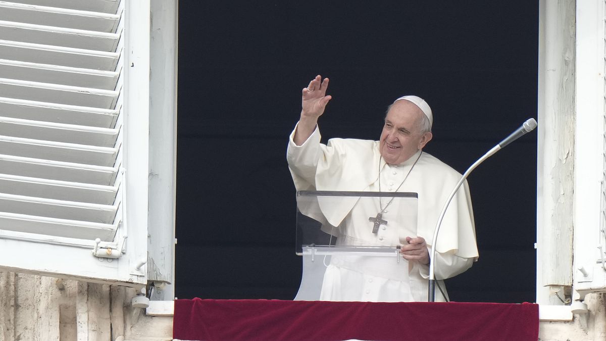 Pope Francis delivers his blessing as he recites the Angelus noon prayer from the window of his studio overlooking St.Peter's Square, at the Vatican, Sunday, Oct. 31, 2021.