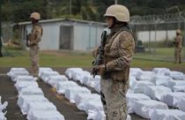 Member of the Panamanian National Air and Naval Service (SENAN) keeps custody of packages of suspected illicit substances that have been seized