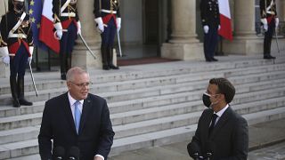 French President Emmanuel Macron, right, watches Australia's Prime Minister Scott Morrison