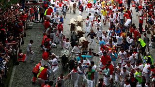 Runners sprint in front of Torrestrella fighting bulls at the during the San Fermin festival in Pamplona, Spain 