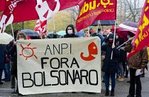 Italian Partisans Association activists march with a banner reading "Bolsonaro out".