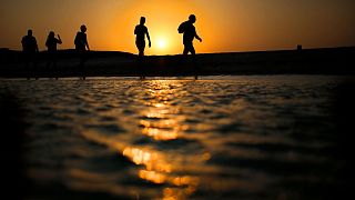 Tourists walk on the Giftun Island beach at the Red Sea resort of Hurghada.