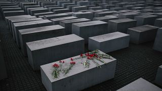 Flowers lie on a concrete slab of the Holocaust Memorial in Berlin.