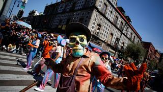 Participants wearing skull masks perform during the annual Day of the Dead parade in Mexico City, Mexico, October 31, 2021.