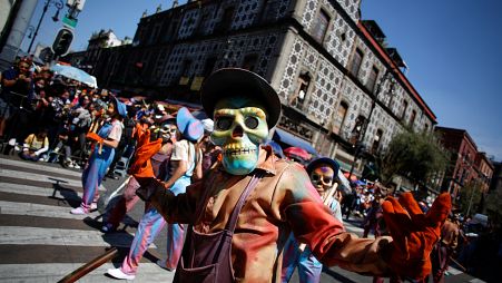 Participants wearing skull masks perform during the annual Day of the Dead parade in Mexico City, Mexico, October 31, 2021.