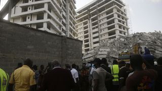 Rescue workers are seen at the site of a collapsed 21-story apartment building under construction in Lagos, Nigeria, Monday, Nov. 1, 2021.