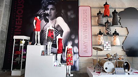 A collection of Amy Winehouse dresses and her drum set are displayed at Julien's Auctions in Beverly Hills, California.