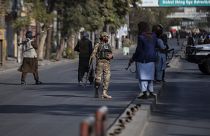 Taliban fighters block roads after an explosion at the entrance of a military hospital in Kabul.