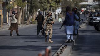 Taliban fighters block roads after an explosion at the entrance of a military hospital in Kabul.
