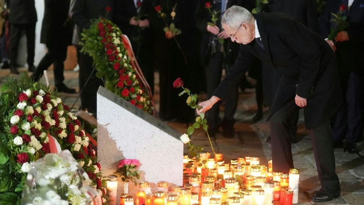 Austria's President Alexander Van der Bellen lays a flower after the memorial service in Vienna.