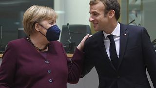 French President Emmanuel Macron, right, and German Chancellor Angela Merkel during a round table meeting at an EU summit in Brussels, Oct. 22, 2021.
