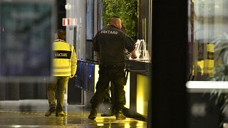 A security guard is seen through the glass at the concert hall "Uppsala Konsert & Kongress" in Uppsala, Sweden, on November 2, 2021.