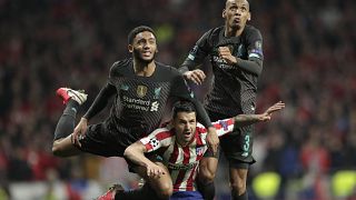 Liverpool's Fabinho, right, and Joe Gomez jump for a header with Atletico Madrid's Vitolo
