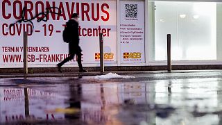 A woman walks past an abandoned coronavirus test center in Frankfurt, Tuesday, Nov. 2, 2021.