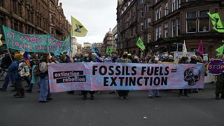 Extension Rebellion activists take part in a demonstration against 'Greenwashing' near the COP26 U.N. Climate Summit in Glasgow, Scotland, Wednesday, Nov. 3, 2021.
