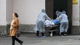 Medical staff members carry a cart with dead body out of the COVID-19 infection department in a city clinic in Kyiv, Ukraine.