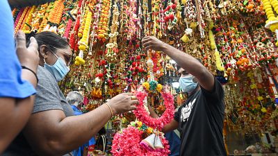 People buy decorative ornaments on the eve of the Hindu festival of Diwali.