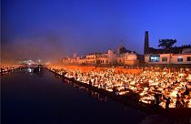 People lighting lamps on the banks of the river Sarayu, Ayodhya