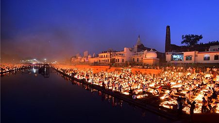 People lighting lamps on the banks of the river Sarayu, Ayodhya