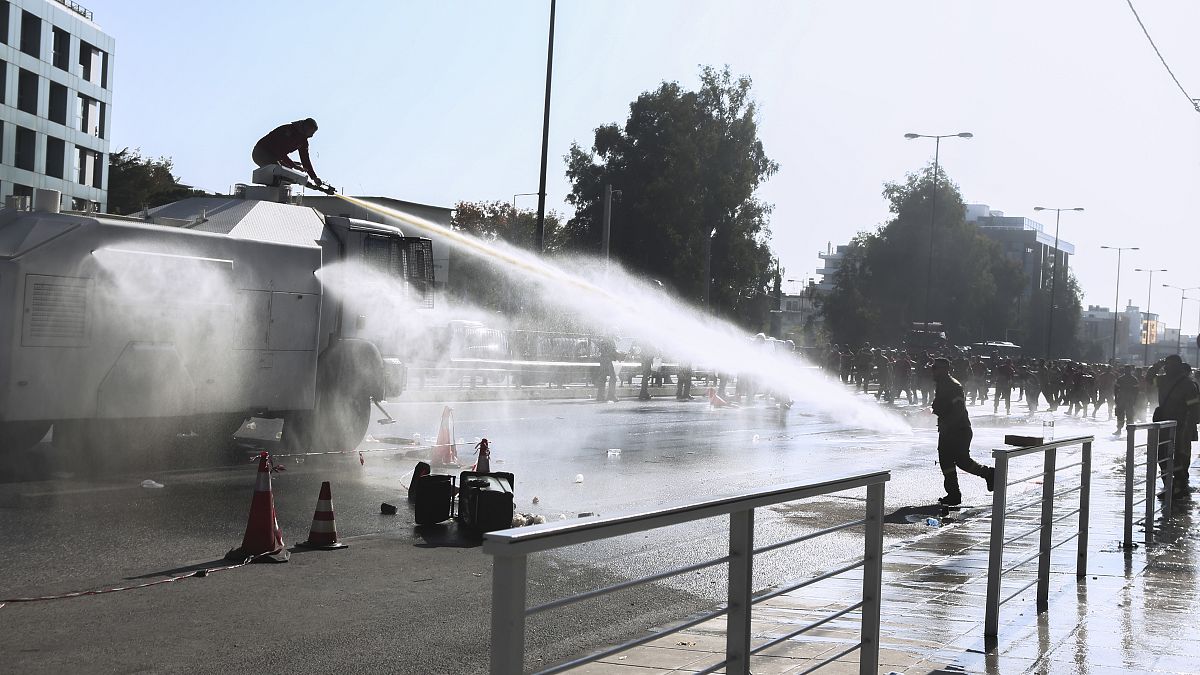 Police fire water cannon at protesting firefighters gathered outside Greece's Climate Change and Civil Protection Ministry in Athens on Friday, Nov. 5, 2021. 