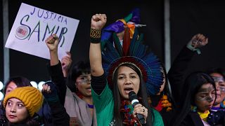 Indigenous people from Brazil speak from the stage during a demonstration in Glasgow, Scotland, Friday, Nov. 5, 2021. 