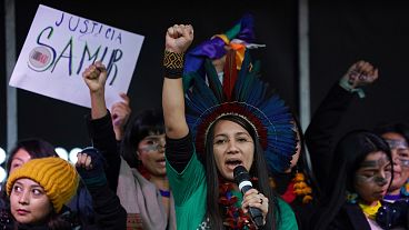 Indigenous people from Brazil speak from the stage during a demonstration in Glasgow, Scotland, Friday, Nov. 5, 2021. 