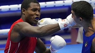 Cuba's Julio La Cruz Peraza, left, fights with Italy's Aziz Abbes Mouhiidine during the men's Heavyweight final of the AIBA World Boxing Championships 2021