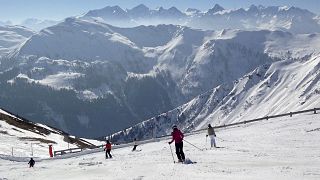 In this March 14, 2014 file photo, people ski at the mountains around Saalbach, Austria.