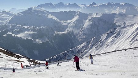 In this March 14, 2014 file photo, people ski at the mountains around Saalbach, Austria.