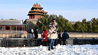 Couple in front of tower in the Forbidden city