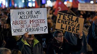 Demonstrators hold a banner reading 'why are you accepting abusive electricity taxes without complaining?' during a protest against rising electricity prices, in Barcelona.