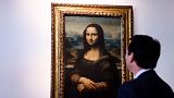 Auctioneer Matthieu Fournier displays the copy of Leonardo da Vinci's Mona Lisa