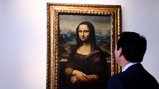 Auctioneer Matthieu Fournier displays the copy of Leonardo da Vinci's Mona Lisa 