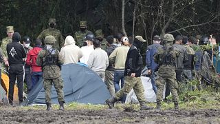 FILE - Polish security forces block migrants on the border with Belarus in Usnarz Gorny, Poland, on Wednesday, Sept. 1, 2021.
