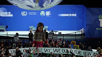 Giant puppet Little Amal walks through the Action Zone inside the venue of the COP26 UN Climate Summit in Glasgow, Scotland, Tuesday, Nov. 9, 2021.