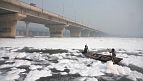 Hindus take holy dip in toxic foam-topped river