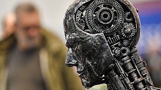 Nov. 29, 2019, file photo, a metal head made of motor parts symbolizes artificial intelligence, or AI, at the Essen Motor Show 